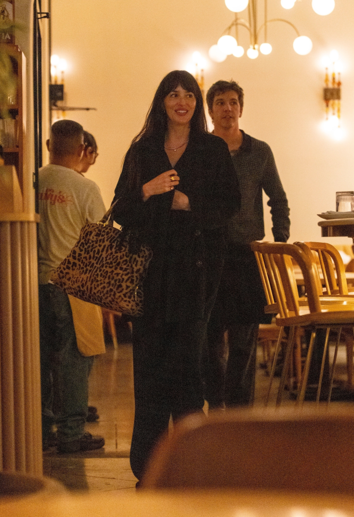 Dakota Johnson and Role Model leaving a restaurant.