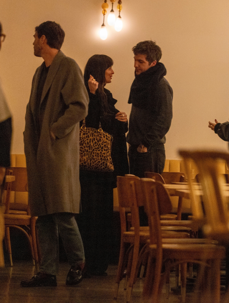 Dakota Johnson and Role Model, with a leopard print bag, at a relaxed dinner with friends.