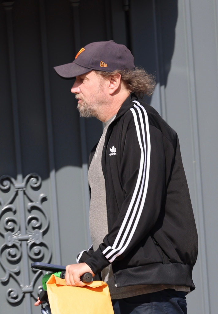 Jamie Kennedy rides a Lime scooter down Sunset Boulevard in Los Angeles.