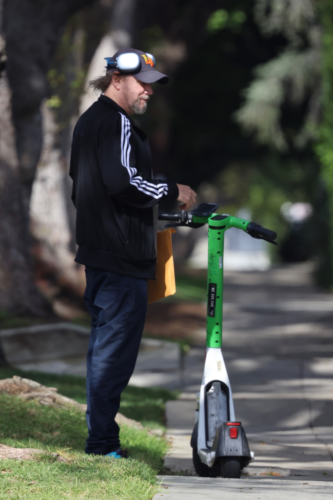 Jamie Kennedy riding a Lime scooter down Sunset Boulevard in Los Angeles.