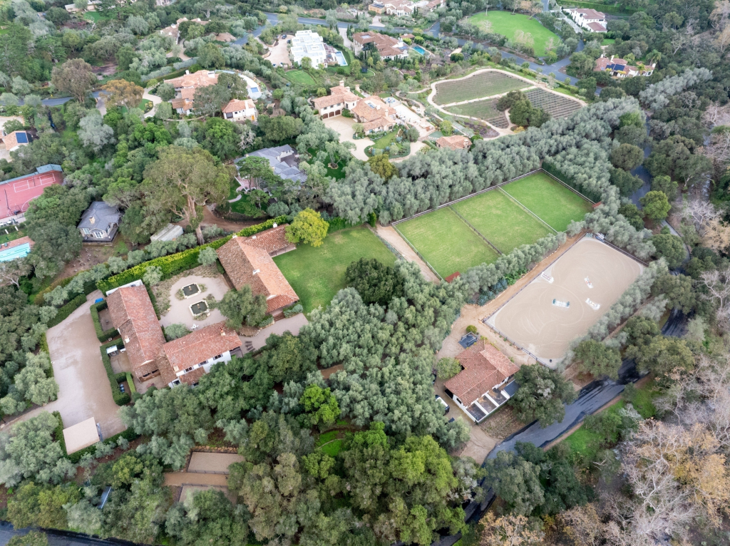 Aerial view of Kendall Jenner's Montecito estate with multiple houses, horse stables, training facilities, and tennis courts surrounded by trees.