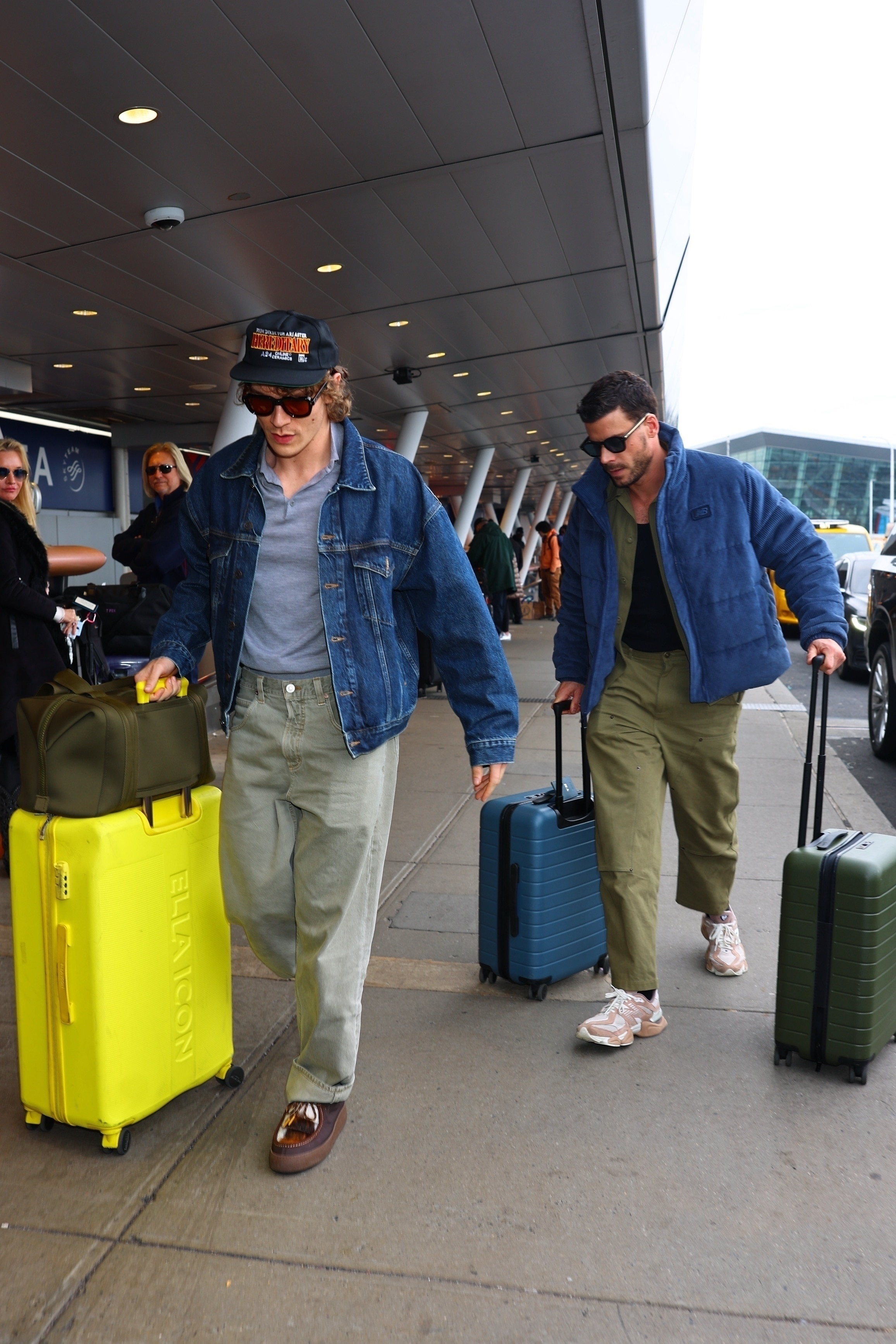 Connor Storrie and François Arnaud depart JFK Airport together with their luggage.