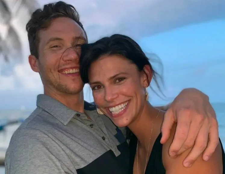 Photo of a man and woman embracing and smiling.