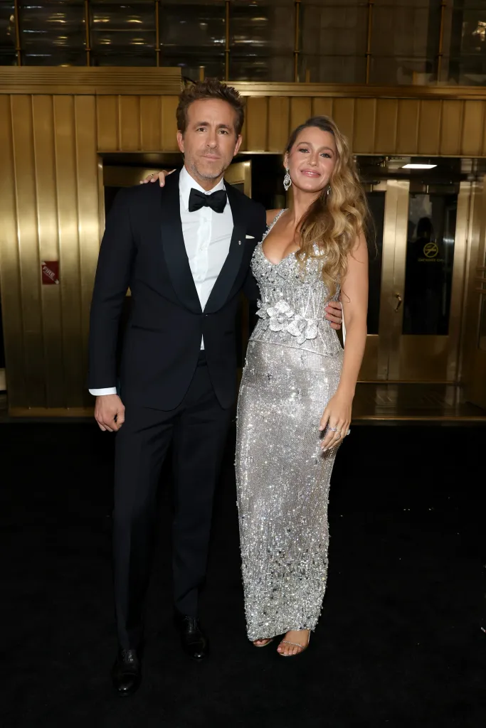 Ryan Reynolds in a black tuxedo and Blake Lively in a shimmering silver gown.