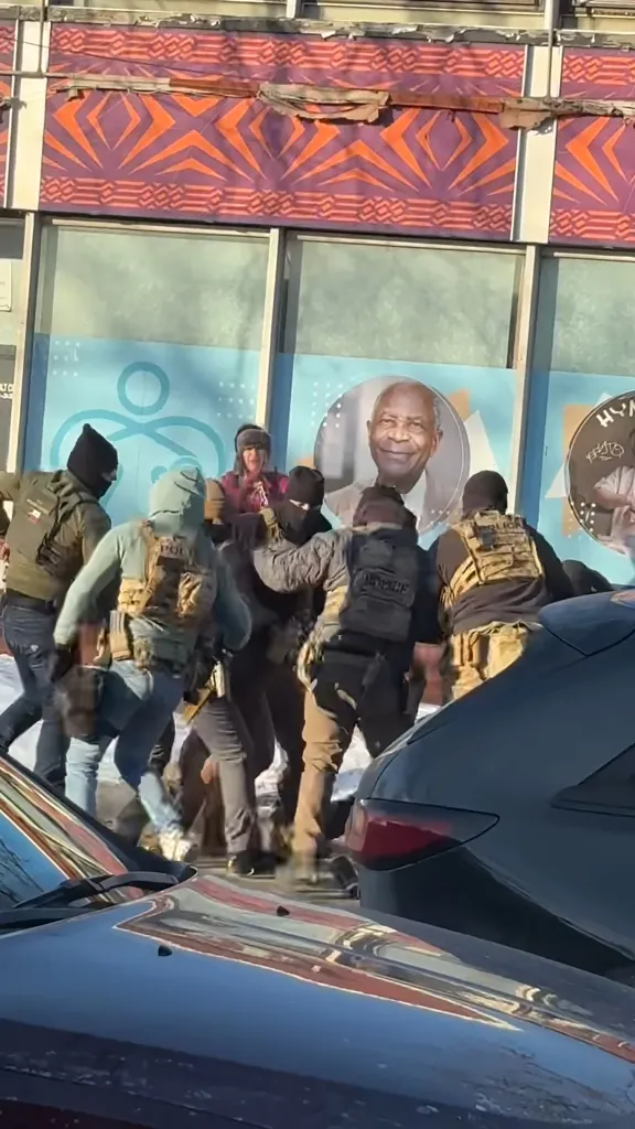 Federal agents detaining a man in Minneapolis' Eat Street neighborhood.