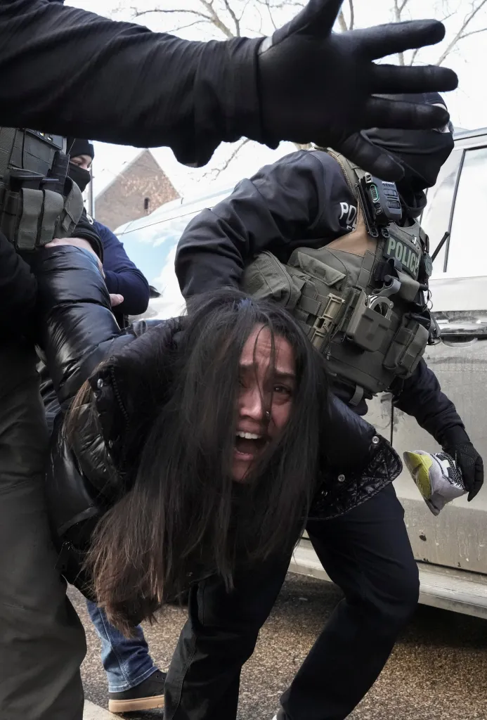 The woman, who has not yet been identified, was pulled from the car as she clung onto the driver's side door.