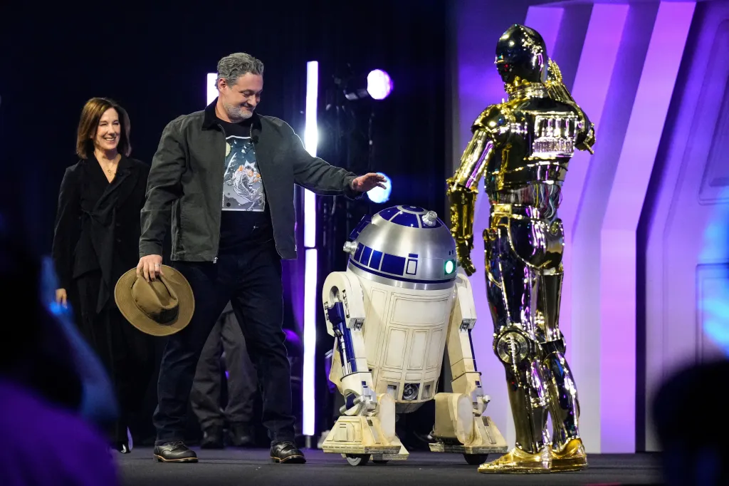 Kathleen Kennedy, Dave Filoni, R2-D2, and C-3PO on stage at the Star Wars Celebration in Chiba.