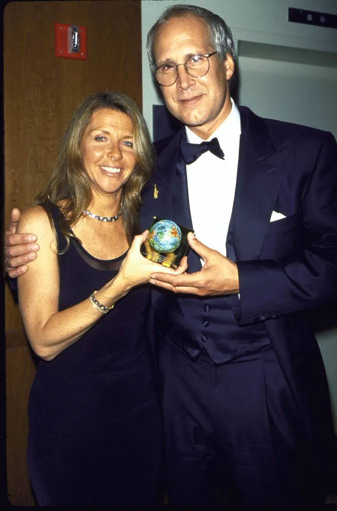 Chevy Chase and wife Jayni holding a globe award.