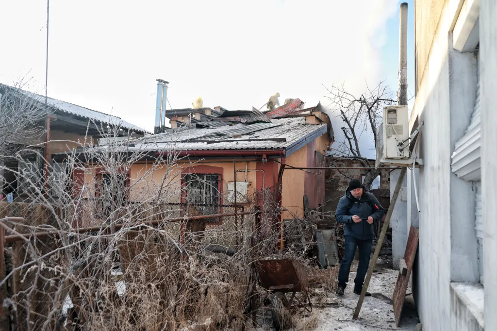 Firefighters extinguish a fire on the roof of a house that broke out following a Russian drone attack in Oleksandrivka, Odesa region, Ukraine, on January 21, 2026