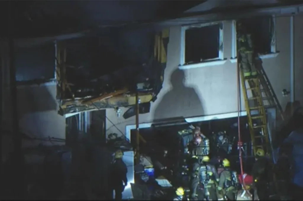 Firefighters at a Bell Gardens home after an explosion caused damage to the second floor.