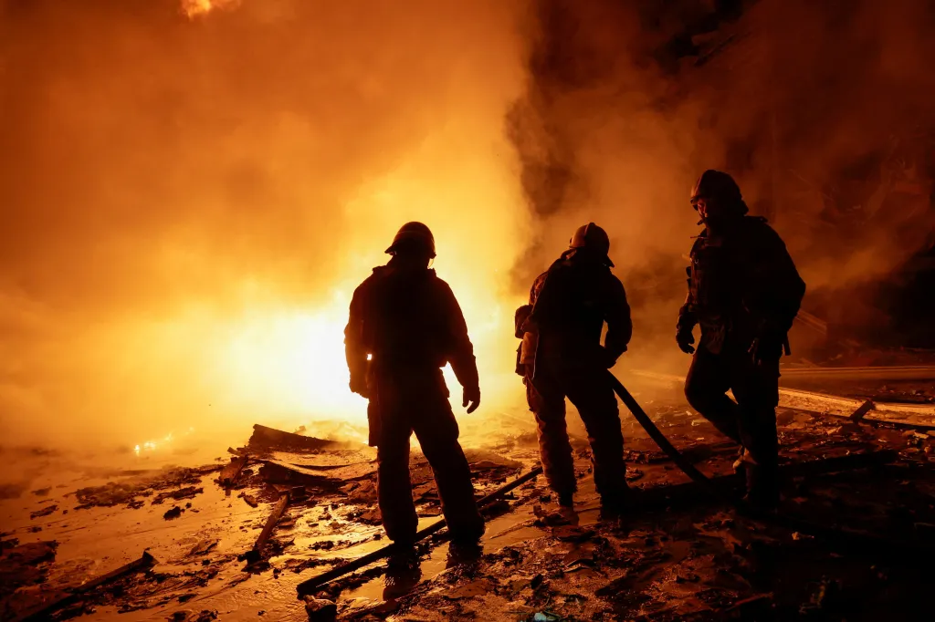 Firefighters work at a logistics hub hit by a Russian missile in Kharkiv, Ukraine.