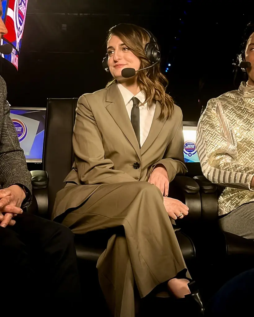 Gabriella Papadaki in a headset, sitting next to two other people in a broadcast booth.