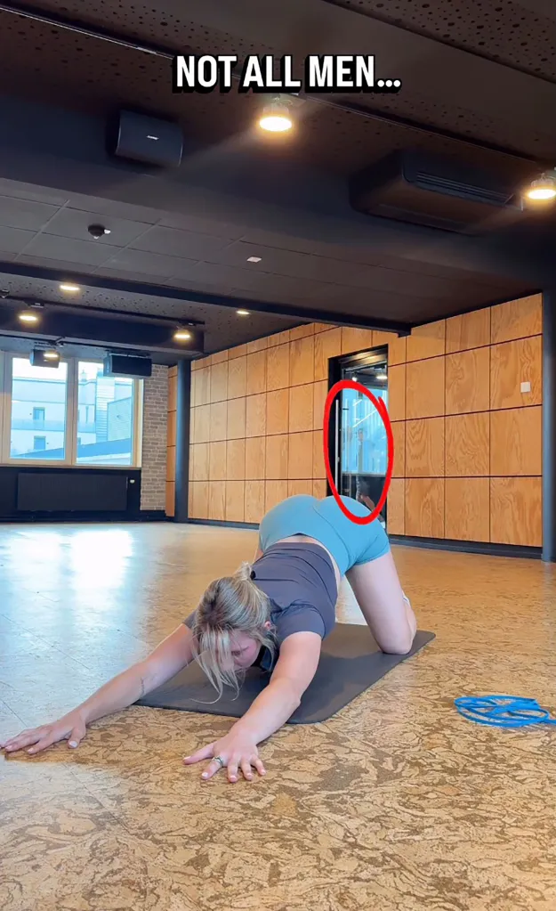 A woman exercising on a yoga mat with a red circle highlighting a person looking in through a glass door.