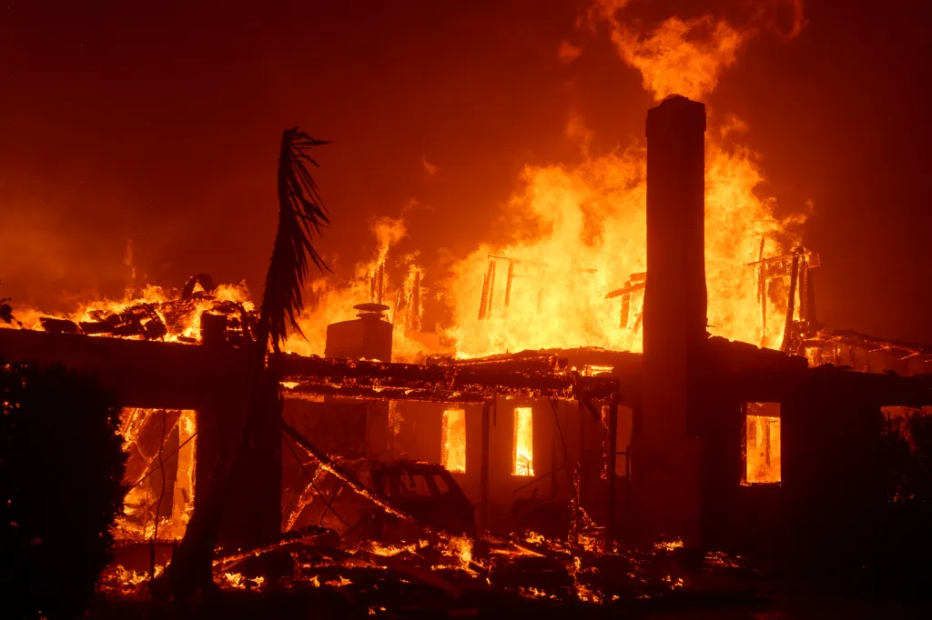 Flames from the Palisades Fire burning a home in Los Angeles.