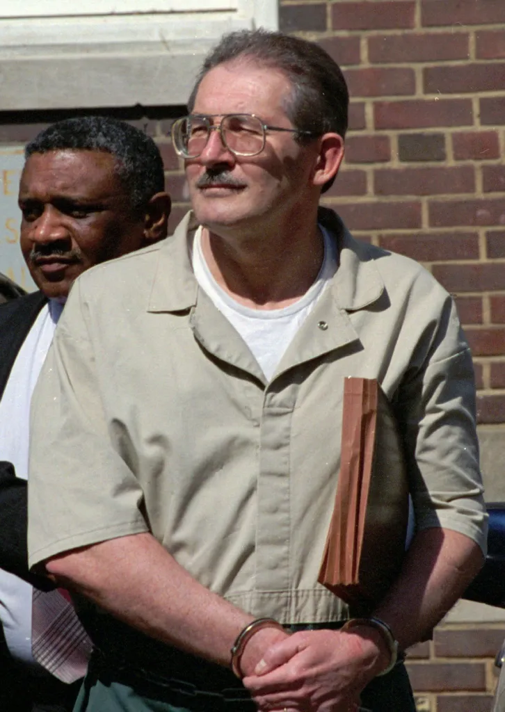 Former CIA agent Aldrich Ames in handcuffs after leaving federal court.