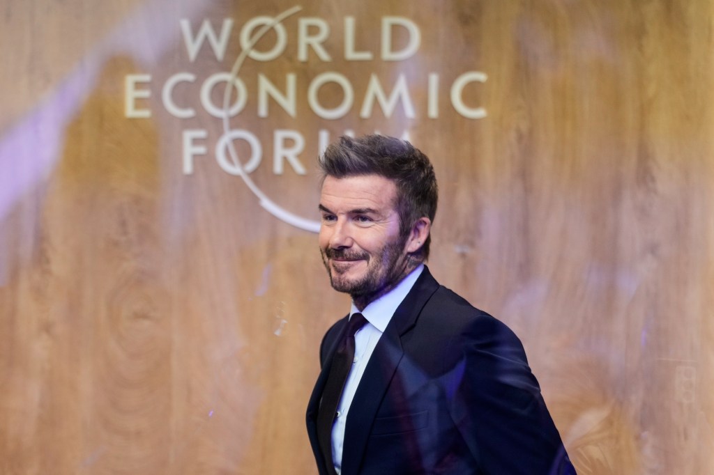David Beckham, in a blue suit, blue tie and white shirt, leaving after a podcast at the World Economic Forum in Davos.