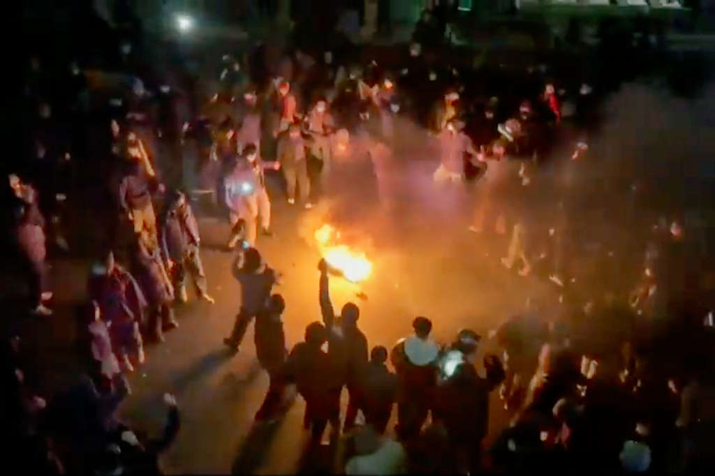 A group of protesters form a circle around a bonfire dancing and cheering in Tehran, Iran, on Jan. 9, 2026. 