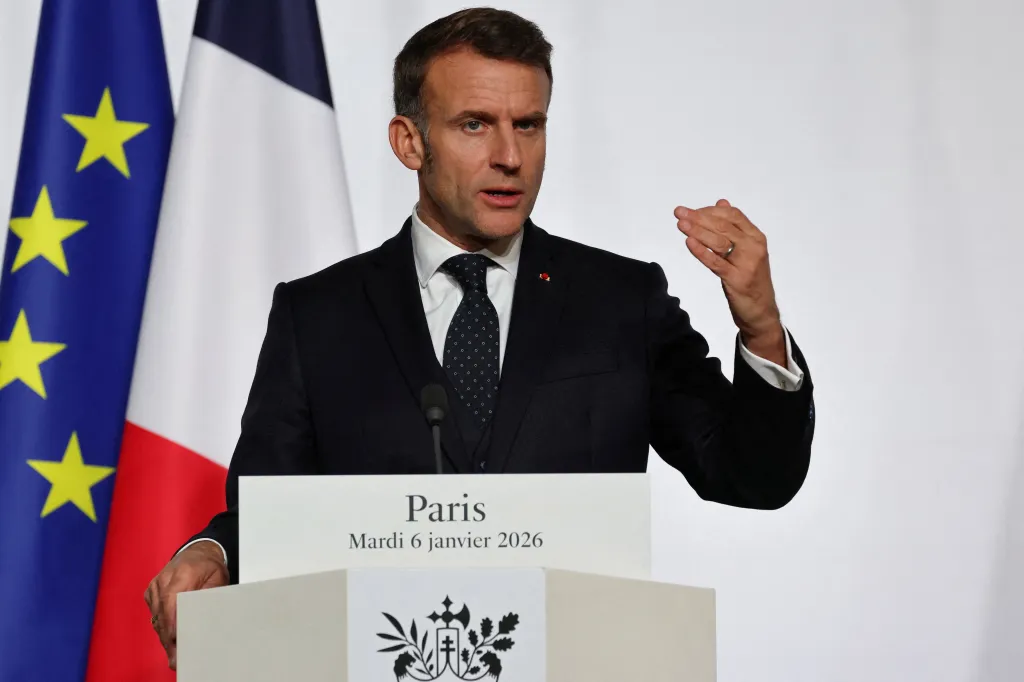 France's President Emmanuel Macron speaking at a press conference in front of French and EU flags.