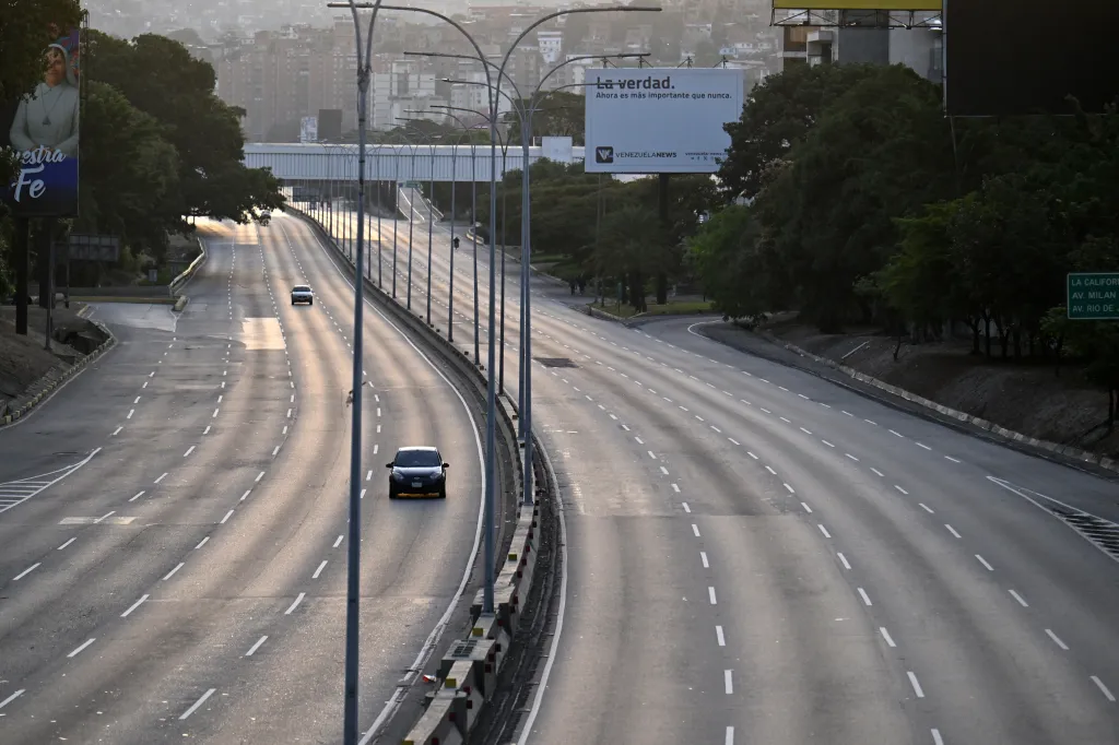 A car is driven on an almost empty highway in Caracas.