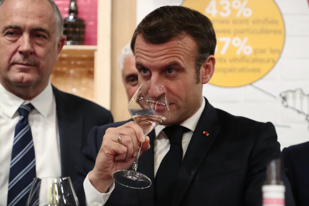 French President Emmanuel Macron holds a glass of wine during the 57th International Agriculture Fair (Salon de l'Agriculture) at the Porte de Versailles exhibition center in Paris, France, on February 22, 2020.