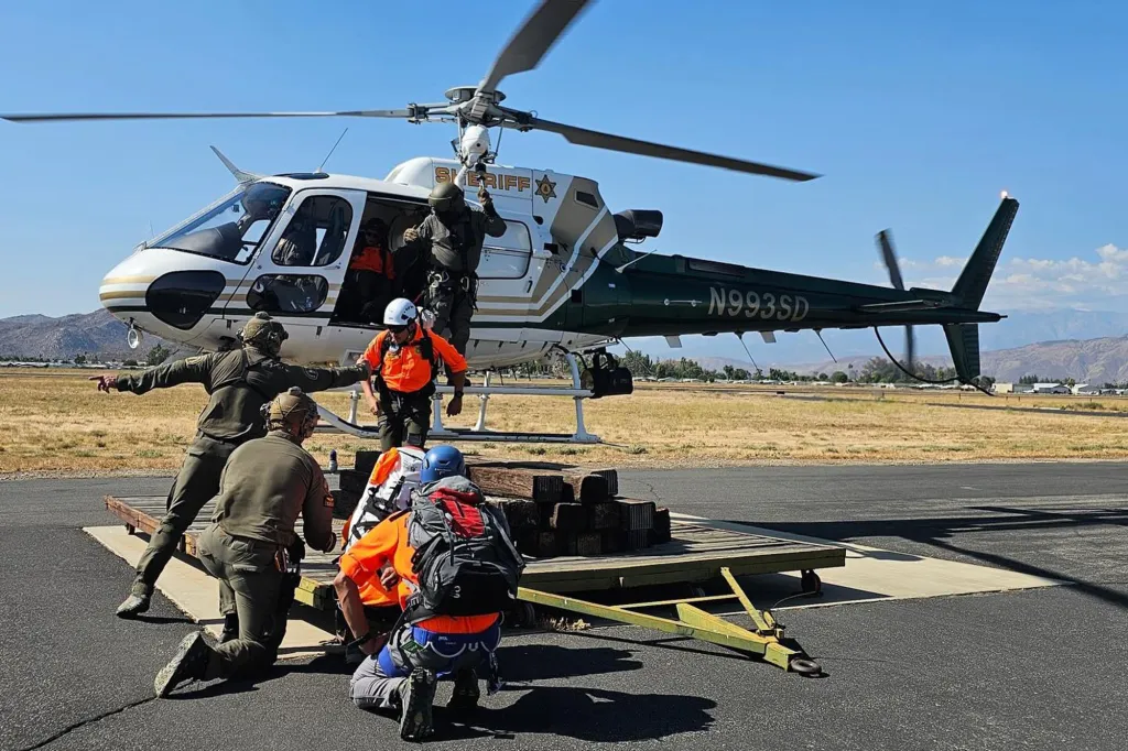 Riverside Mountain Rescue Unit members during a training exercise with a sheriff's helicopter.
