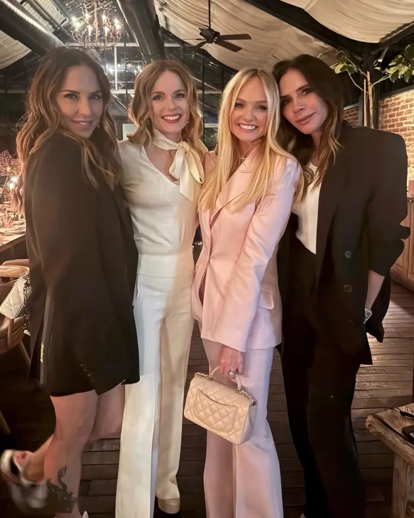 Four women, Melanie C, Geri Halliwell, Emma Bunton, and Victoria Beckham, pose together at a party.