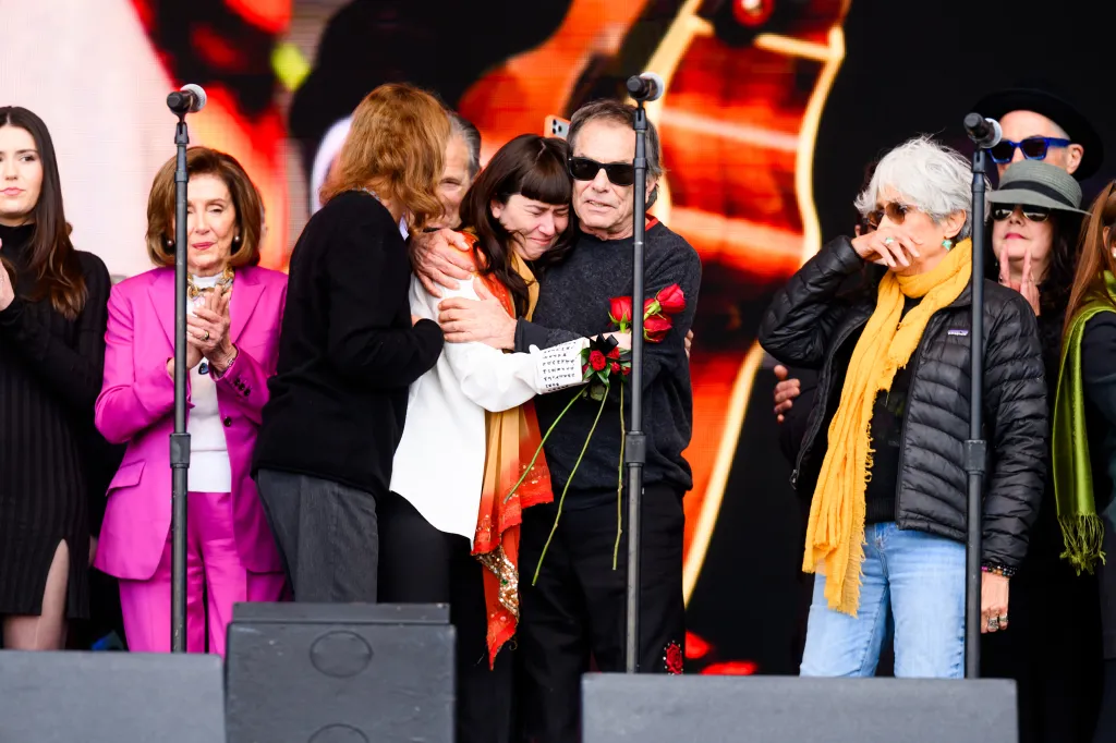 Grateful Dead drummer Mickey Hart hugs daughter Reya Hart during the memorial for Bob Weir.
