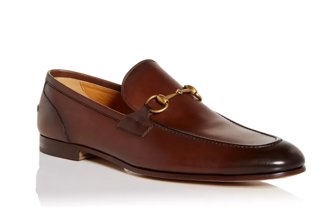 Brown leather Gucci loafers with a gold-tone horsebit detail.
