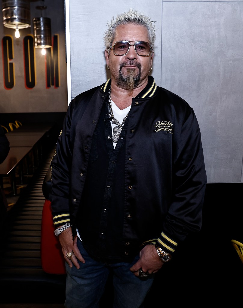 Guy Fieri in a black jacket and sunglasses opens Chicken Guy! restaurant in Times Square.