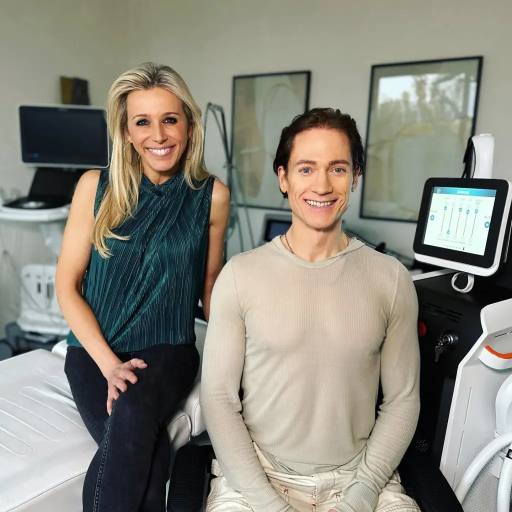 Lara Lewington and Bryan Johnson smiling in a room with medical equipment.
