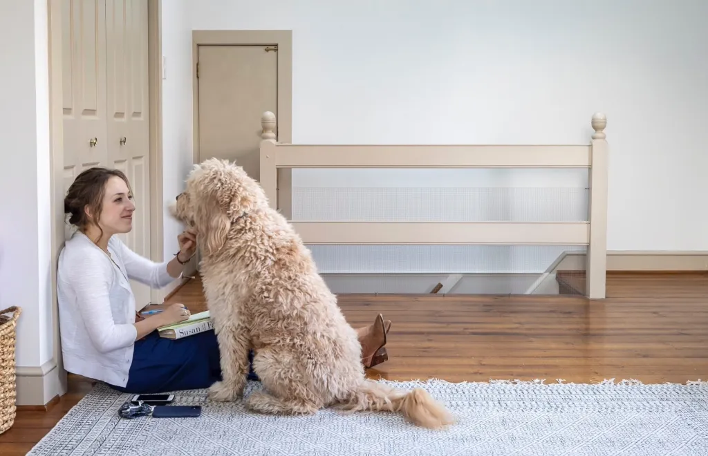 Hannah Natanson sitting on the floor with her dog.