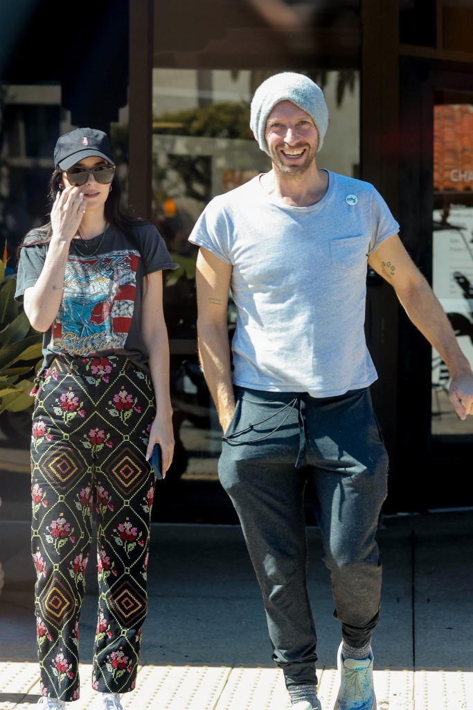 Chris Martin smiling at the camera and Dakota Johnson holding her sunglasses on a coffee run in Malibu.