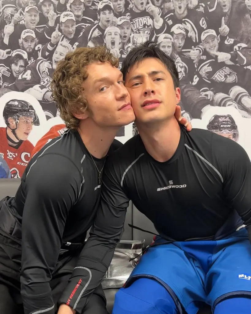 Actors Hudson Williams and Connor Storrie in character in hockey gear.