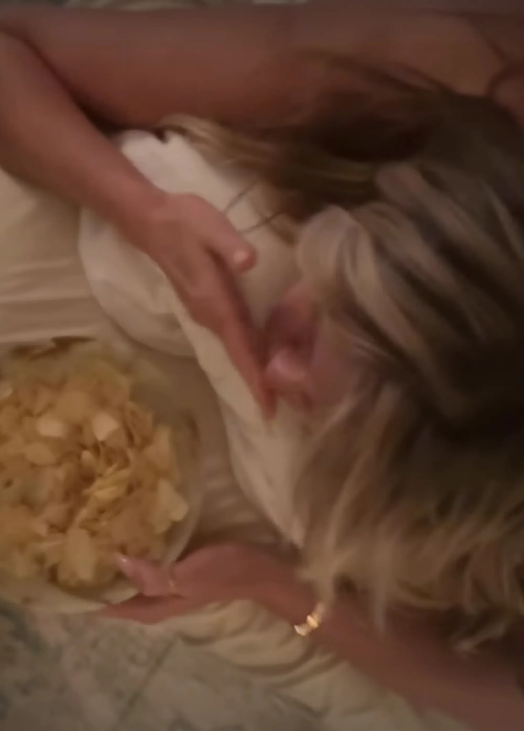 Heidi Klum eating greasy chips while getting a butt massage.