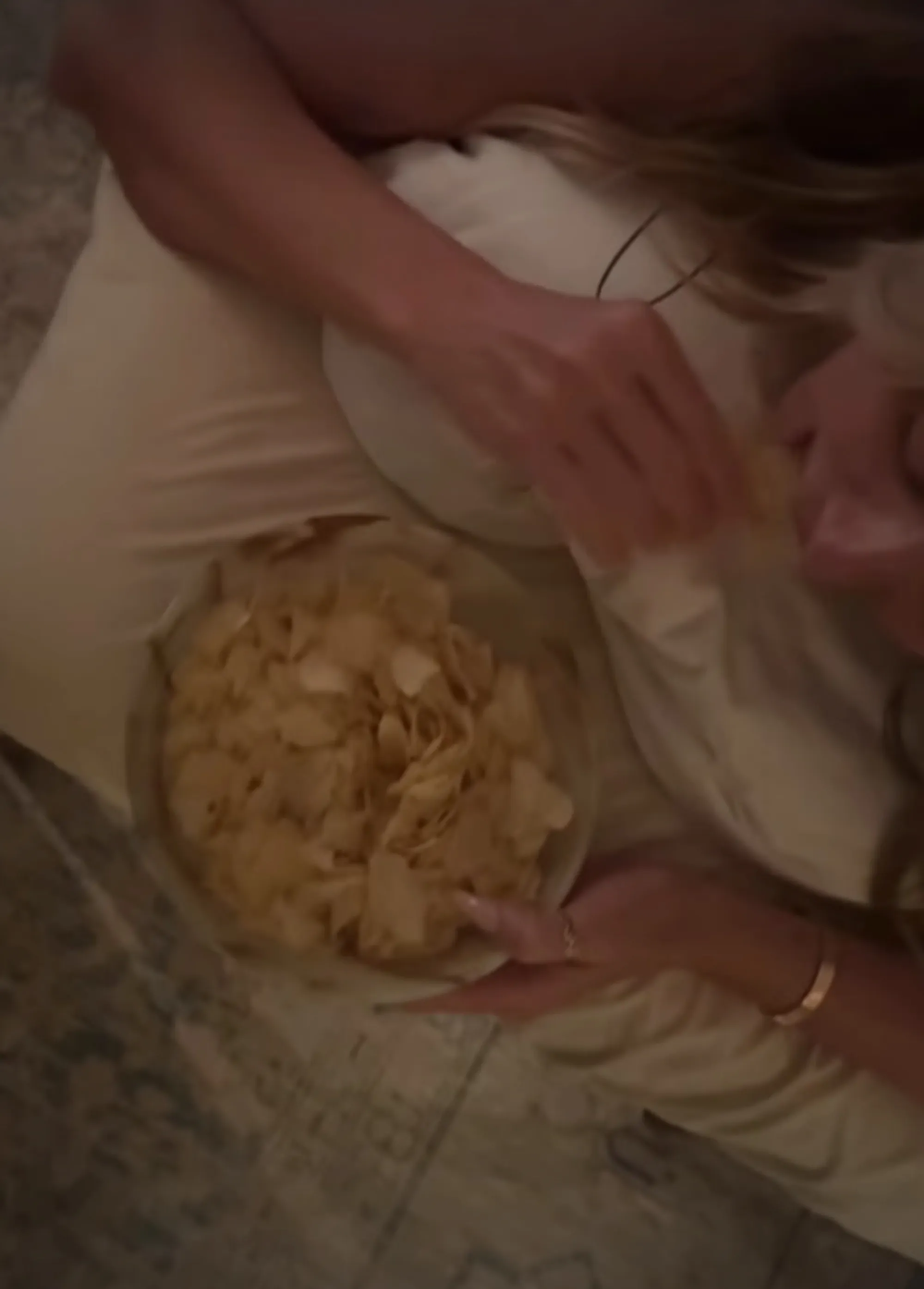 Heidi Klum eating potato chips while getting a butt massage.