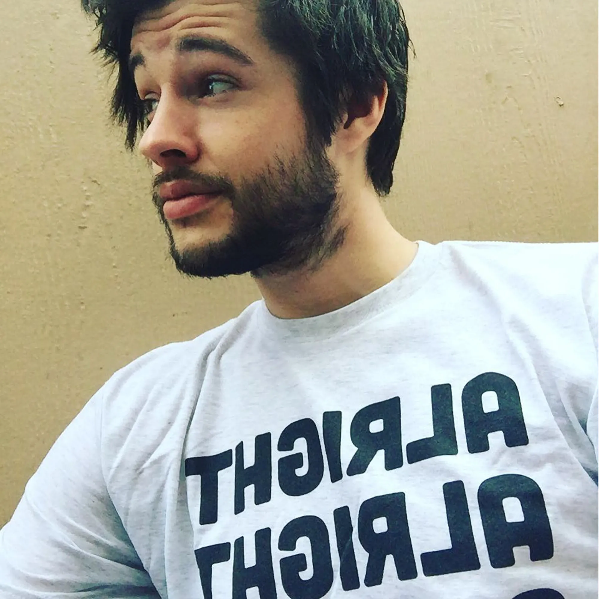 Matt Prokop wearing a light gray t-shirt with the text 