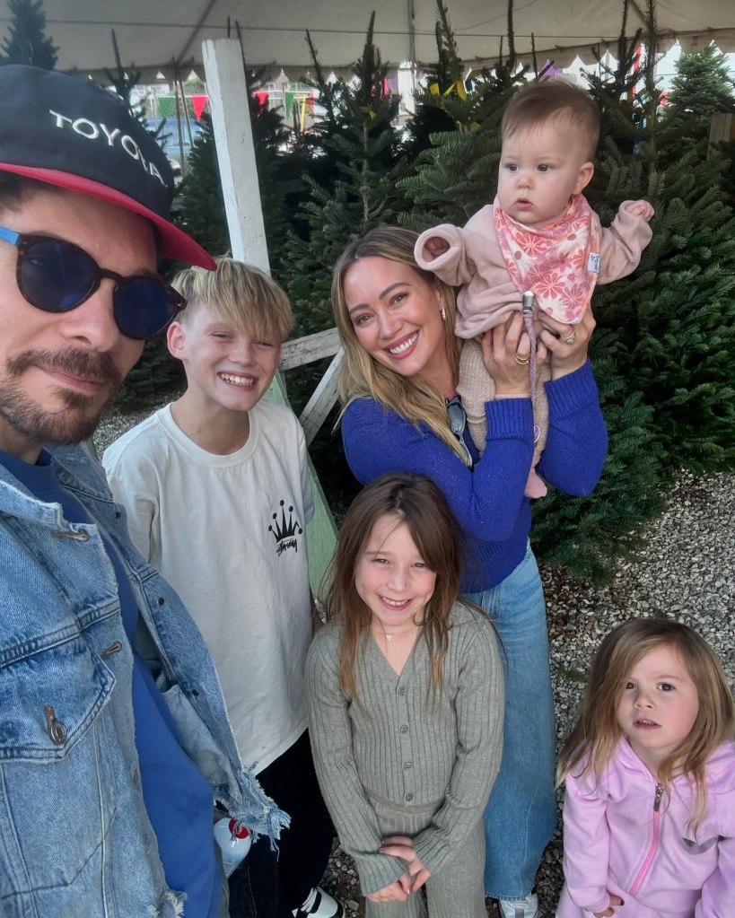 Hilary Duff, Matthew Koma, and their four children posing for a photo.