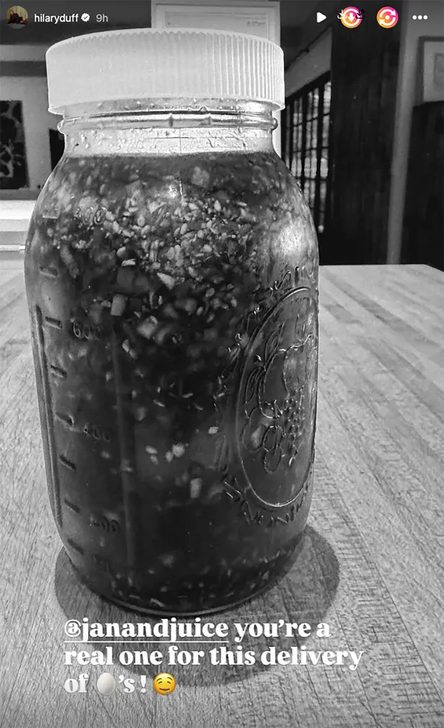 Black and white photo of a large mason jar filled with a dark, chunky liquid, with text thanking @janandjuice for the delivery.