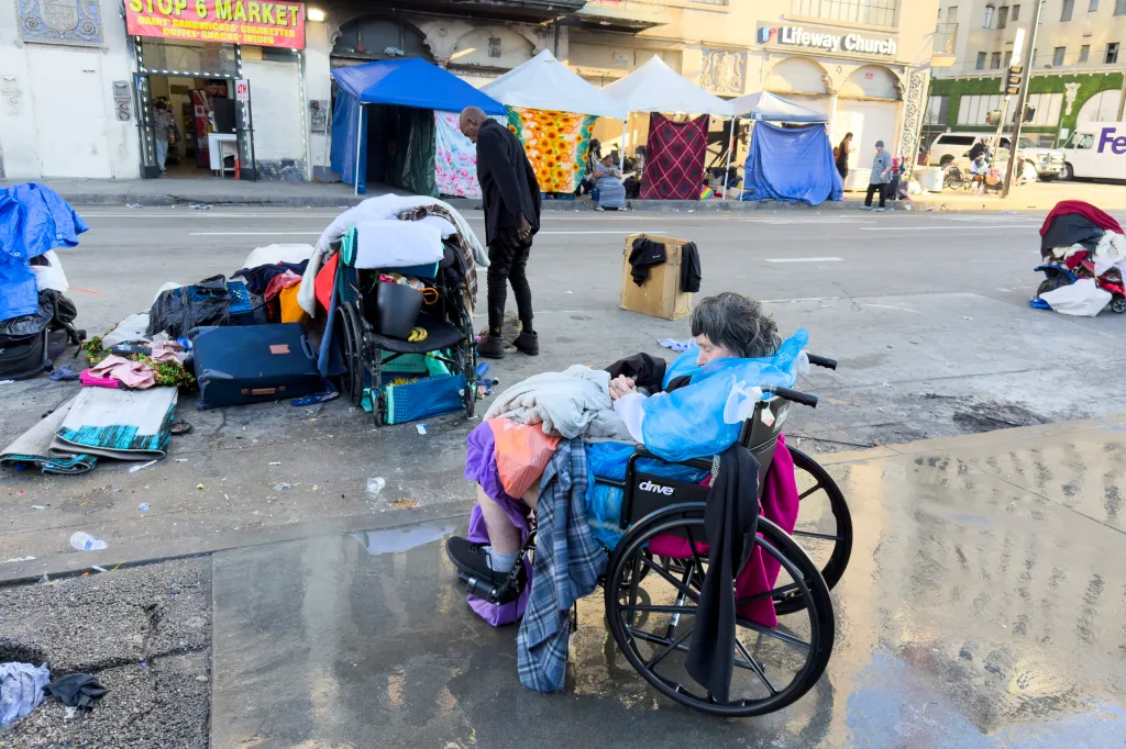 Homeless people and their belongings scattered across the street in Skid Row, Los Angeles.