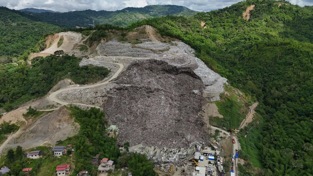 A huge mound of garbage collapsed into a landslide killing at least four workers.