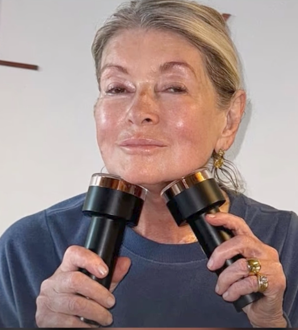 Martha Stewart holding two Lyma facial devices to her jawline.