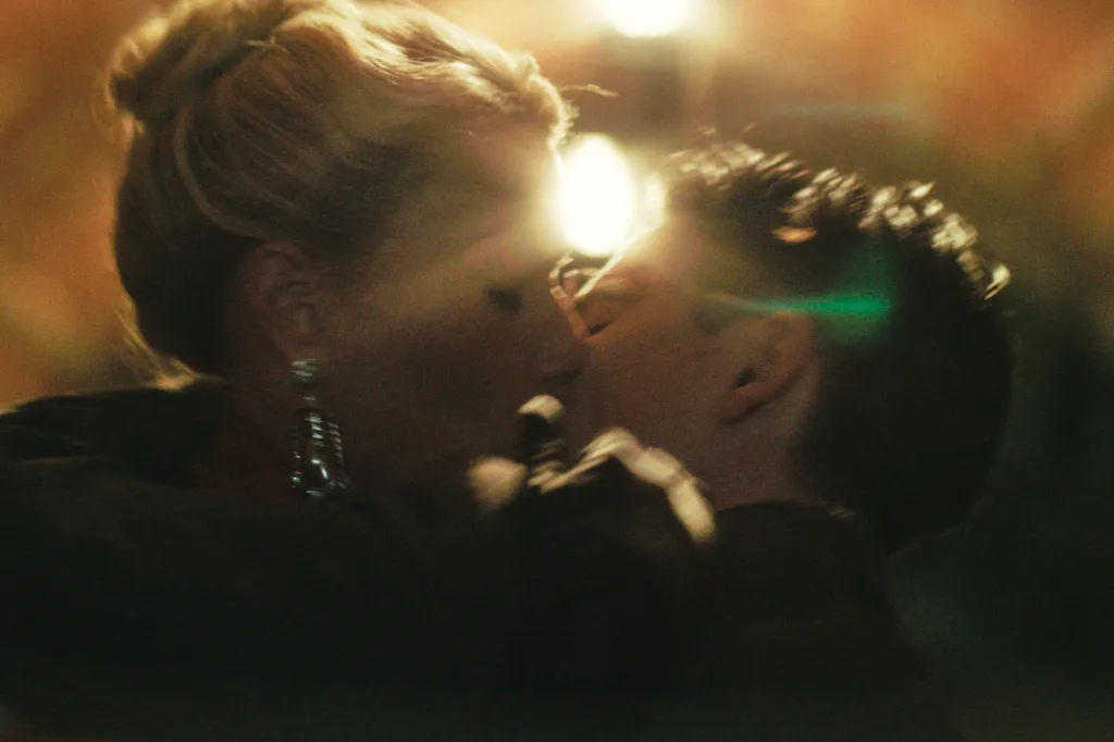 Gwyneth Paltrow and Timothée Chalamet kissing, obscured by bright light and shadows.