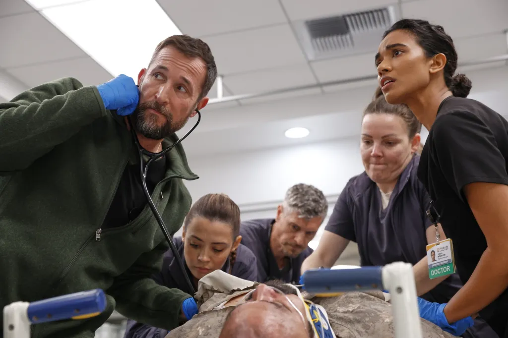 Noah Wyle and other medical staff attend to a patient in a scene from 