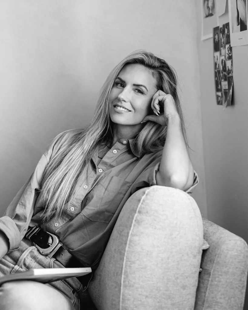 Paige Steckling smiling while sitting in a chair.