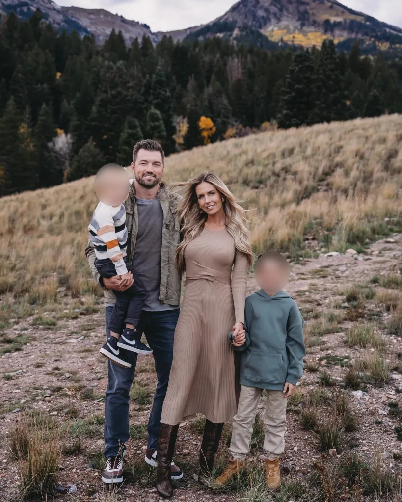 The Steckling family of four standing in a field with mountains in the background.
