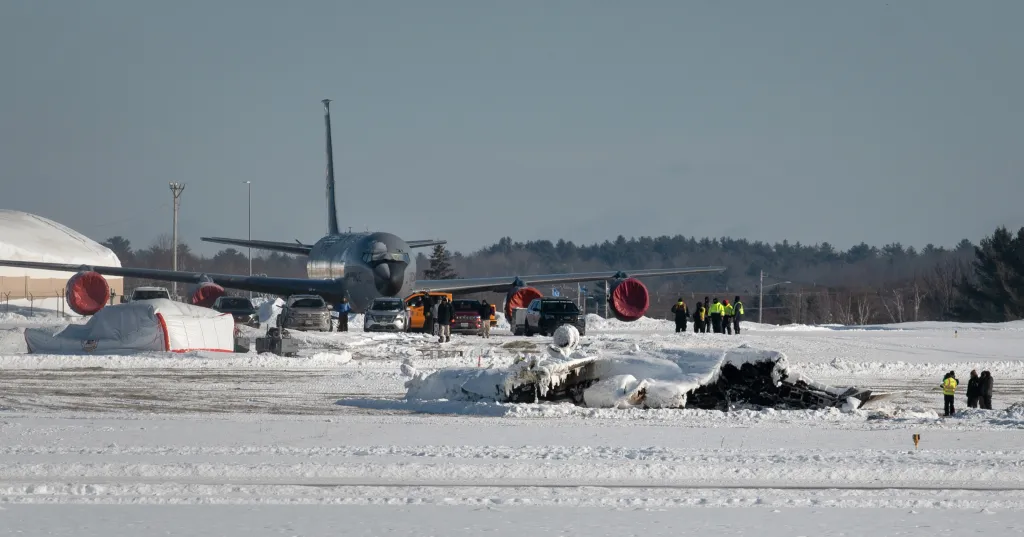 Investigators at the scene of a plane crash at Bangor International Airport, Maine.
