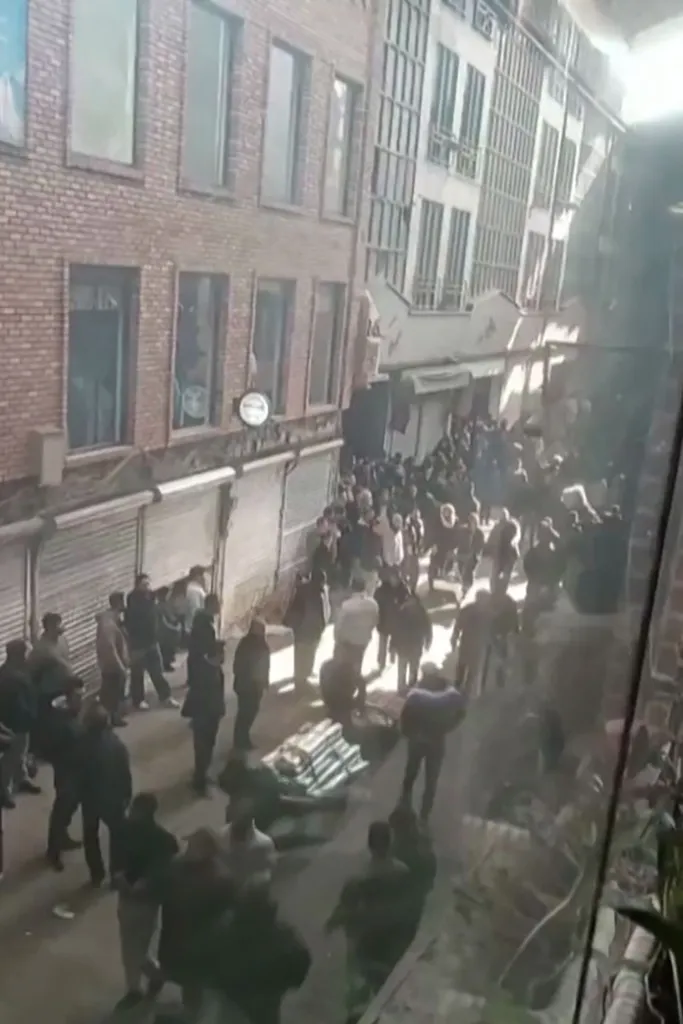 People protesting during clashes with security forces in the Tehran bazaar.