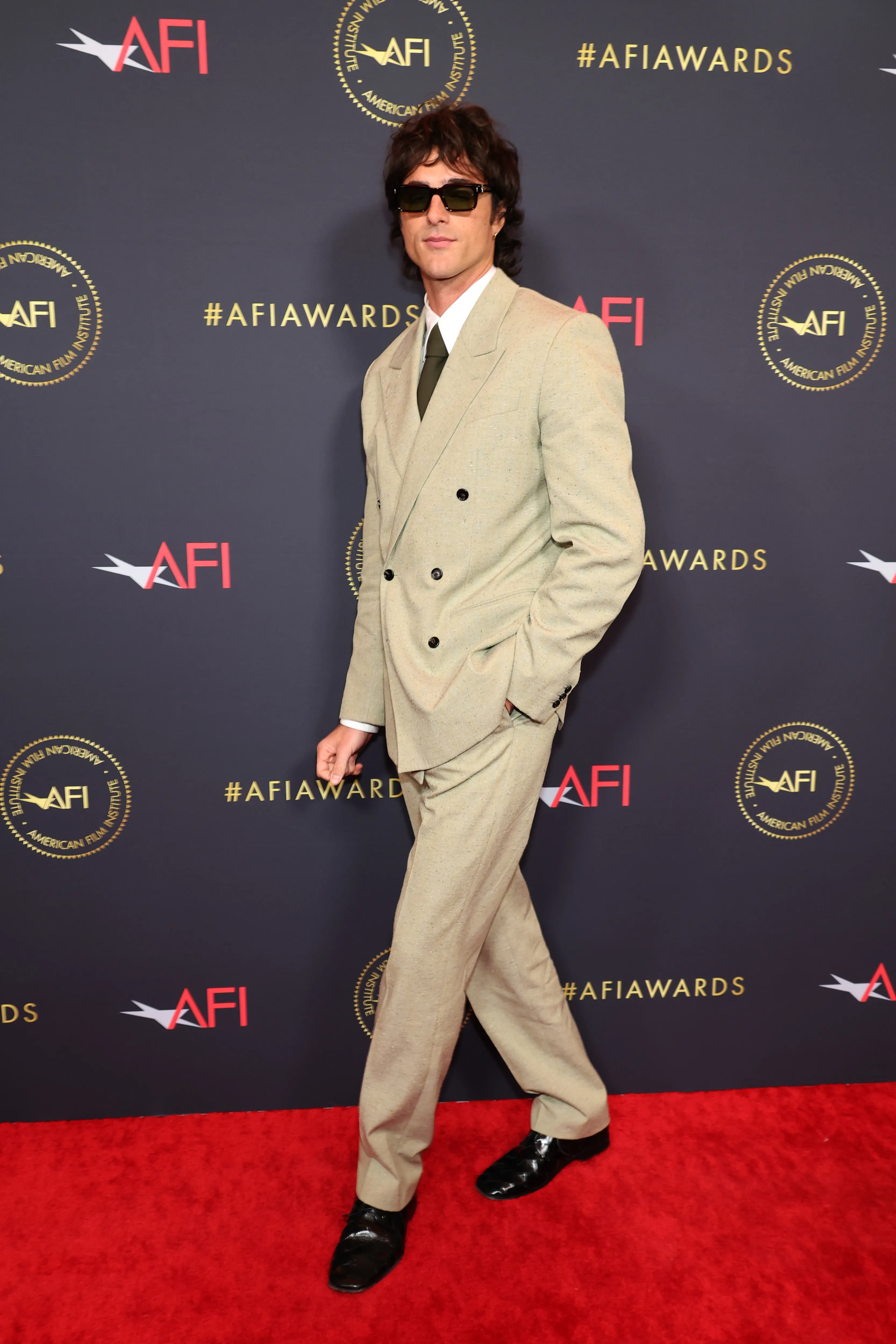 Jacob Elordi in a tan suit and sunglasses at the AFI Awards Luncheon.