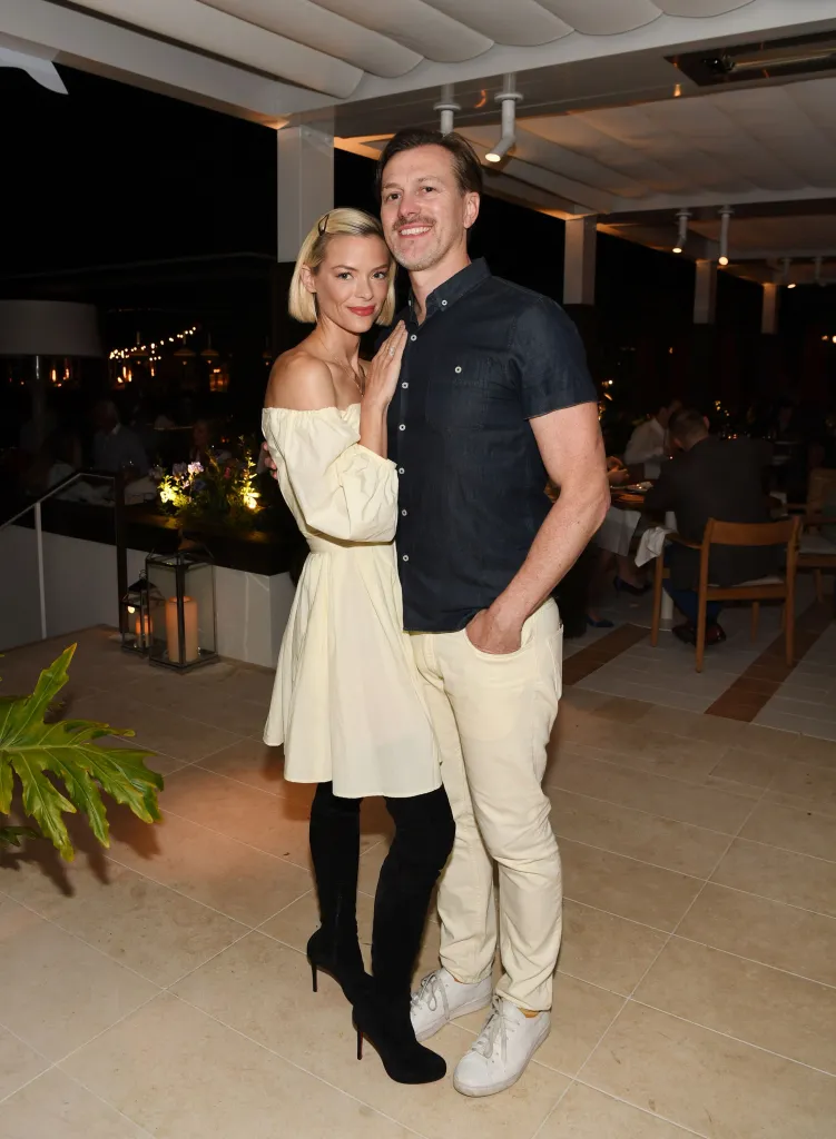 Jaime King and Kyle Newman standing and posing for a photo.