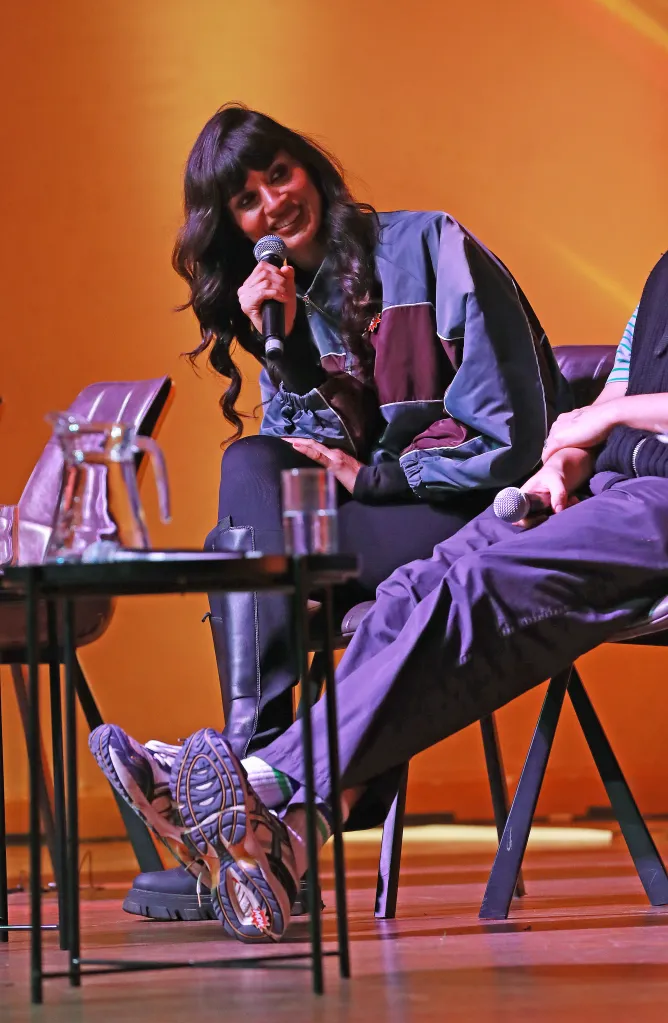 Jameela Jamil speaks into a microphone onstage at the WOW Presents...An Evening With Jordan Stephens & Friends event.
